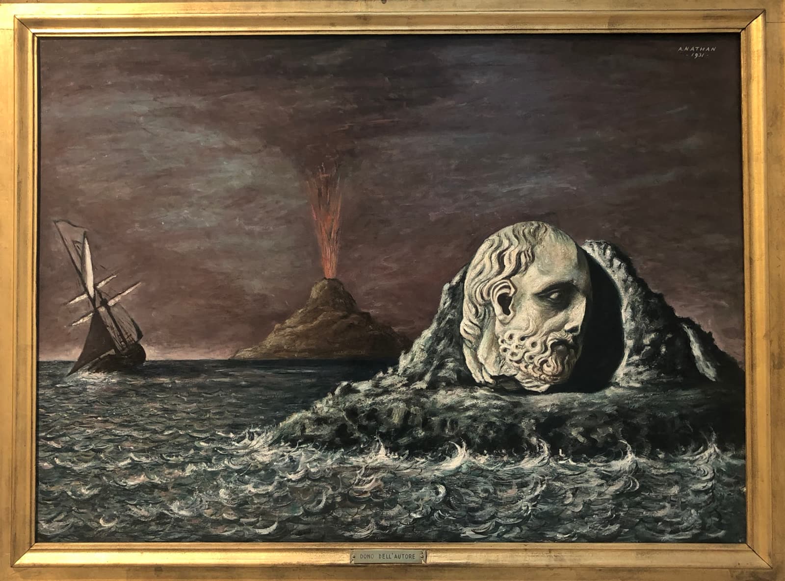Tableau encadré : visage de pierre dans la mer, voilier et volcan